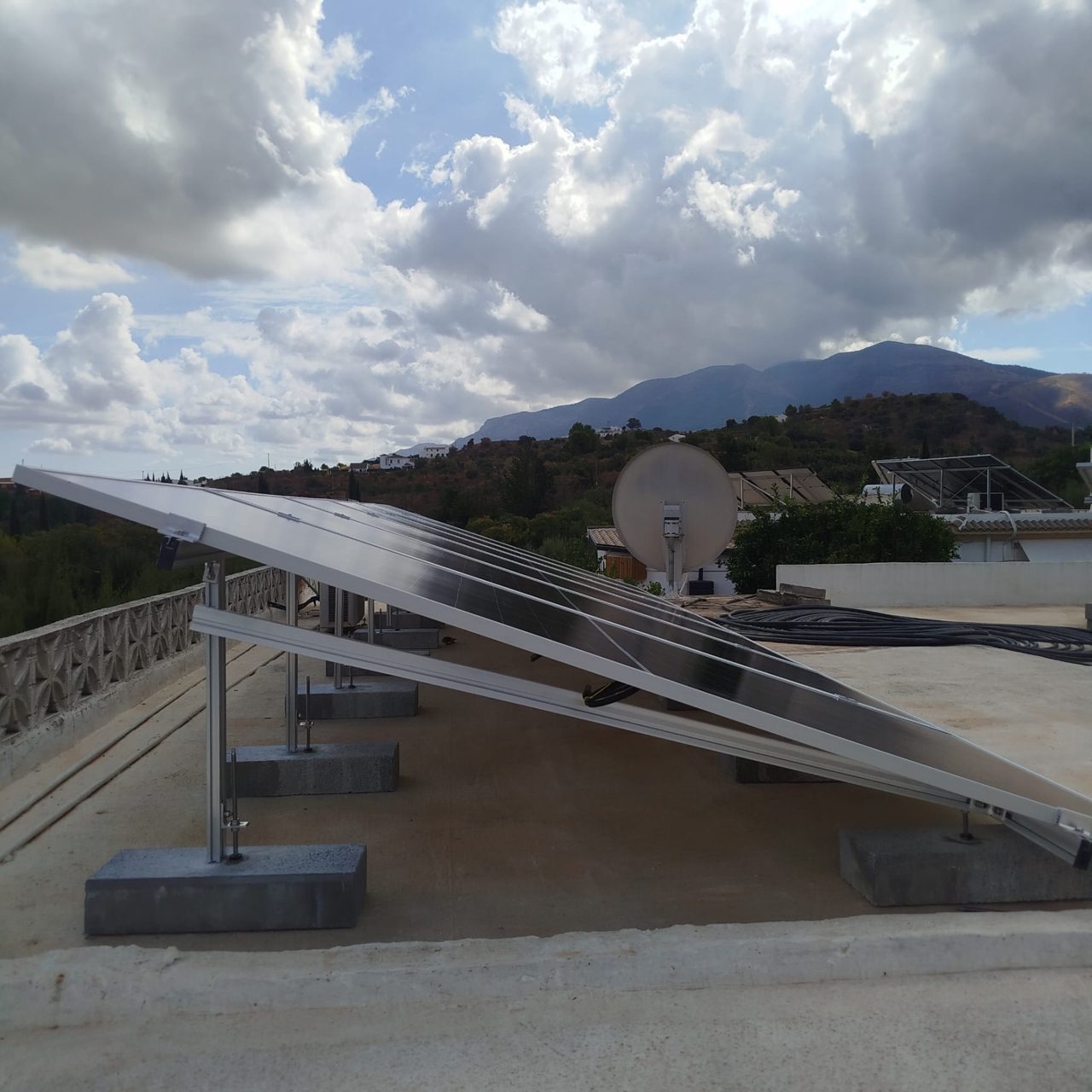 Side view of the solar panels on the tilted structure on the flat roof in Alhaurín de la Torre