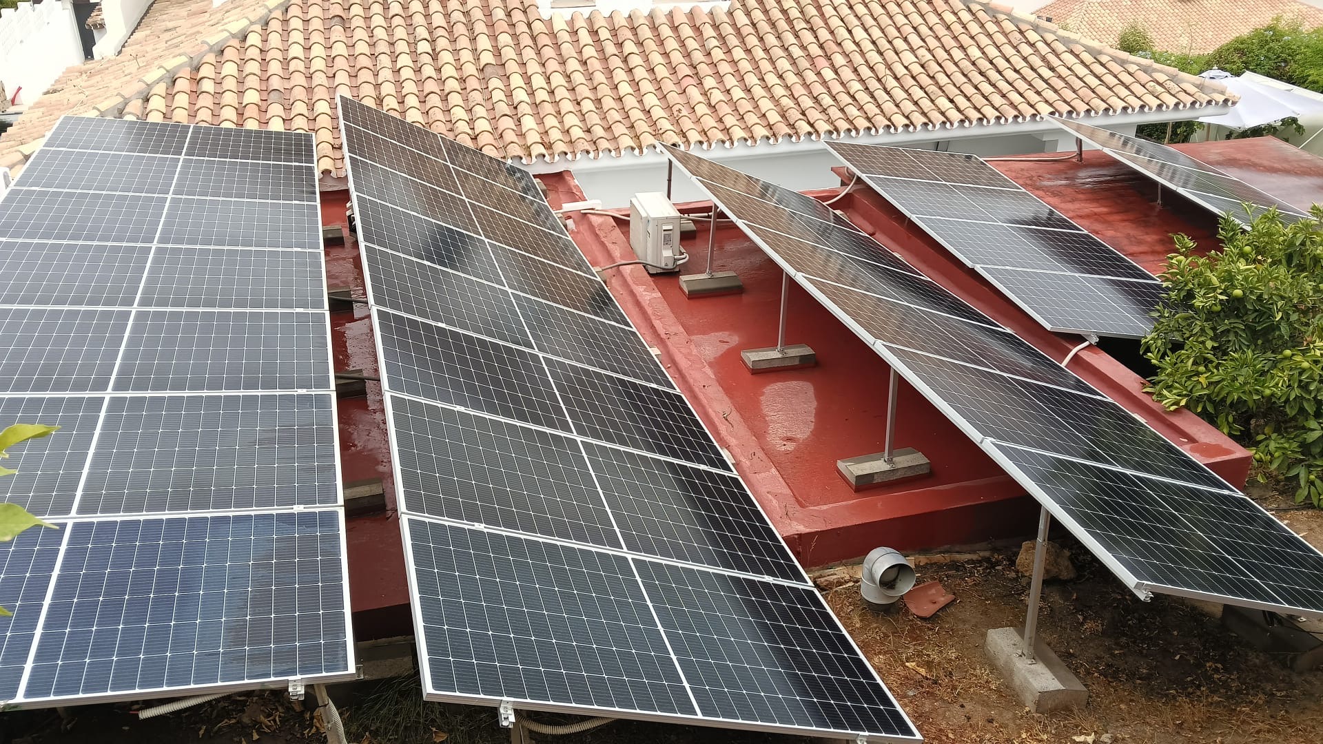 Solar panels on a flat roof with mounting frames during a maintenance visit