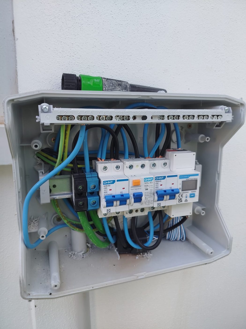 Open protection enclosure with circuit breakers, RCD and smart meter wired after correcting the installation in Benahavís