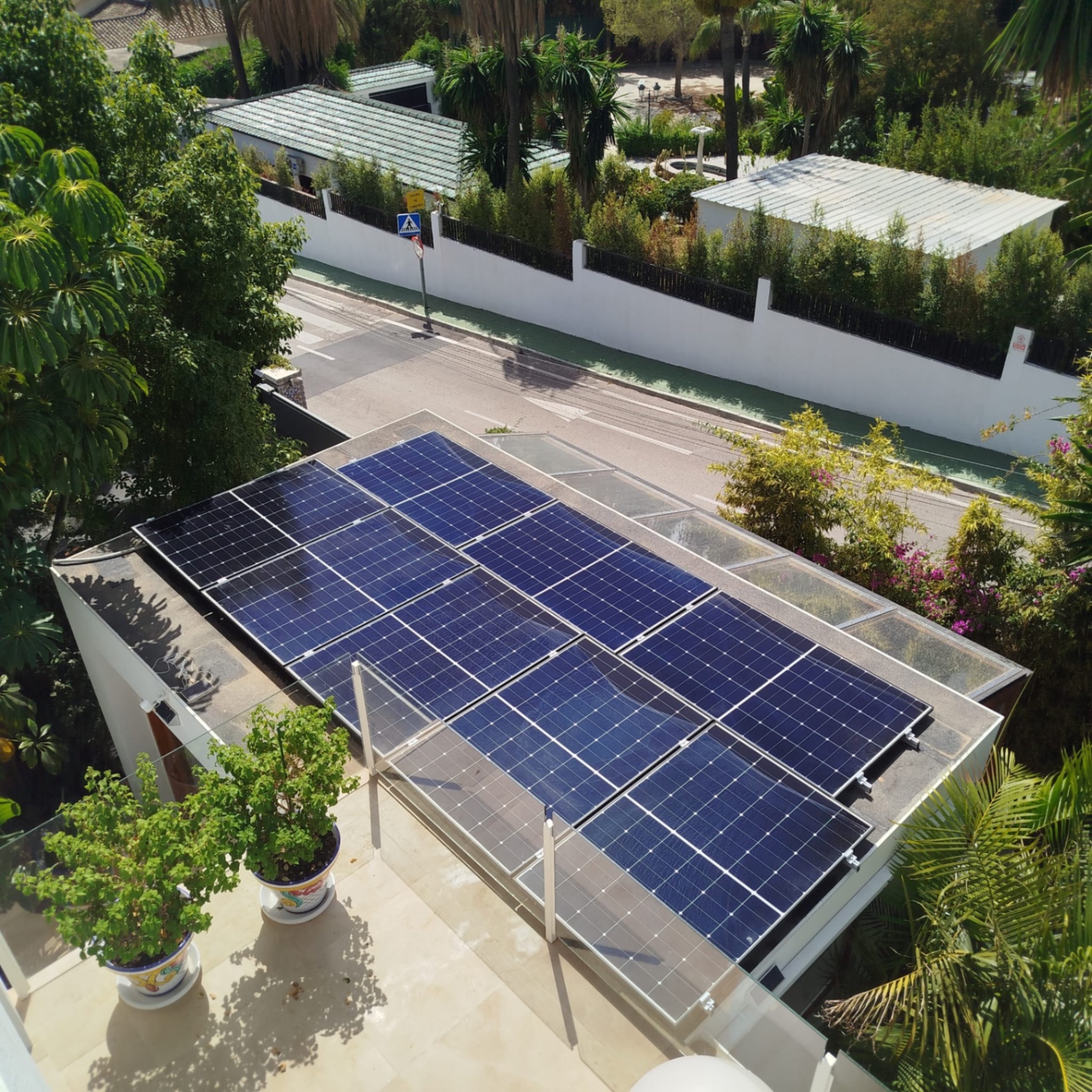 Clean solar panels mounted above a glass pergola roof after optimisation